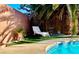 Cozy backyard pool area with a lounge chair and artificial grass at 5368 Regal Ave, Las Vegas, NV 89146