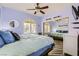 Comfortable bedroom with a ceiling fan and a mirrored closet reflecting the room at 5489 Royal Vista Ln, Las Vegas, NV 89149
