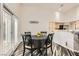 Cozy dining area with access to outdoor space and a view into the open kitchen layout at 5489 Royal Vista Ln, Las Vegas, NV 89149