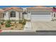 Charming single-story home with a two-car garage, desert landscaping, and tiled roof at 5489 Royal Vista Ln, Las Vegas, NV 89149