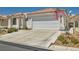 Charming single-story home with a two-car garage, desert landscaping, and tiled roof at 5489 Royal Vista Ln, Las Vegas, NV 89149