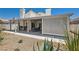 Backyard view showing the patio with a dining table and outdoor grilling area at 5489 Royal Vista Ln, Las Vegas, NV 89149