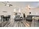 Open-concept living area with modern flooring, comfortable seating, and adjacent dining space at 5489 Royal Vista Ln, Las Vegas, NV 89149