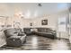 Open-concept living room featuring sleek floors, neutral walls, and comfortable leather seating arrangement at 5489 Royal Vista Ln, Las Vegas, NV 89149