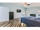A view of the main bedroom featuring a ceiling fan, a door to the outside, and a television at 5489 Royal Vista Ln, Las Vegas, NV 89149