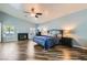 Spacious main bedroom featuring a fireplace, ceiling fan, and windows providing natural light at 5489 Royal Vista Ln, Las Vegas, NV 89149
