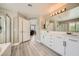 Spacious bathroom with double vanity, walk-in shower, and white cabinets offering ample storage at 6103 Sundown Crest St, Las Vegas, NV 89113