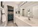 Bright bathroom with double sinks, a large mirror, and white cabinets for a clean, modern look at 6103 Sundown Crest St, Las Vegas, NV 89113