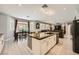 Open kitchen features an island, granite countertops, modern appliances, and backyard view at 6103 Sundown Crest St, Las Vegas, NV 89113
