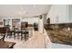 Bright kitchen boasts an island, granite countertops, stainless appliances, and white cabinets at 6103 Sundown Crest St, Las Vegas, NV 89113