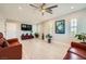 Bright living room with wood-look floors, ceiling fan, and natural light from multiple windows with plantation shutters at 6103 Sundown Crest St, Las Vegas, NV 89113