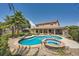 Beautiful backyard with pool, spa, and covered patio, surrounded by lush landscaping and mature trees at 6103 Sundown Crest St, Las Vegas, NV 89113