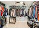 Organized walk-in closet featuring tiered shelving, rods, and storage bins for efficient use of space at 6103 Sundown Crest St, Las Vegas, NV 89113