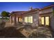 Enclosed backyard and covered patio with space for seating and entertaining at twilight at 615 Cervantes Dr, Henderson, NV 89014