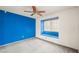 Bedroom featuring a vibrant blue accent wall, a ceiling fan, and built in window seating at 615 Cervantes Dr, Henderson, NV 89014
