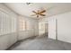 Bedroom featuring ceiling fan, large window, and neutral carpet at 615 Cervantes Dr, Henderson, NV 89014