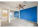 Bedroom featuring a vibrant blue accent wall and a large mirrored closet at 615 Cervantes Dr, Henderson, NV 89014