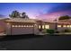 Exterior view of home with attached garage and beautiful sunset at 615 Cervantes Dr, Henderson, NV 89014