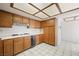 Bright kitchen features tiled floors, wood cabinets, white appliances, and gas range at 615 Cervantes Dr, Henderson, NV 89014