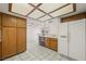 Well-lit kitchen features tiled floors, wood cabinets, and white appliances at 615 Cervantes Dr, Henderson, NV 89014