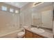 This bathroom features a shower and tub combination with tile surround and single sink vanity at 6241 Overhang Ave, Henderson, NV 89011
