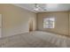 Large bedroom with neutral walls, plush carpet, a ceiling fan, and a window offering natural light at 6241 Overhang Ave, Henderson, NV 89011