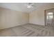 A spacious bedroom with neutral carpet and a ceiling fan offers a calm, inviting space at 6241 Overhang Ave, Henderson, NV 89011