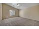 Spacious bedroom with vaulted ceiling, neutral walls, plush carpet, and a large window with blinds at 6241 Overhang Ave, Henderson, NV 89011