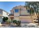 Inviting two-story home featuring a two-car garage and well-maintained landscaping at 6241 Overhang Ave, Henderson, NV 89011