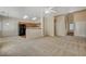 Spacious living room with plush carpet adjacent to the kitchen at 6241 Overhang Ave, Henderson, NV 89011