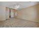 Spacious living room with plush carpet and a neutral color palette at 6241 Overhang Ave, Henderson, NV 89011