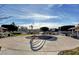 Community splash pad area with colorful rainbow water feature, picnic benches, and a well-maintained play area under a blue sky at 6241 Overhang Ave, Henderson, NV 89011