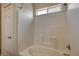 This tiled tub/shower features a convenient window, door and built in storage at 6241 Overhang Ave, Henderson, NV 89011