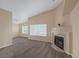 Open-concept living room features a cozy fireplace and carpet flooring at 6250 W Flamingo Rd # 51, Las Vegas, NV 89103