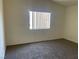 Bright bedroom featuring a neutral color scheme, plush carpet, and a large window at 6340 Cranberry Ln, Las Vegas, NV 89156