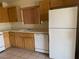 Functional kitchen featuring white appliances, ample cabinet space and durable tile flooring at 6340 Cranberry Ln, Las Vegas, NV 89156