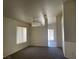 Bright living room featuring plush carpeting and a large window at 6340 Cranberry Ln, Las Vegas, NV 89156