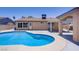 Backyard pool area with a covered patio and desert landscaping at 6358 Meadow Lark Ln, Las Vegas, NV 89103