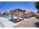 Backyard pool area with a covered patio and desert landscaping at 6358 Meadow Lark Ln, Las Vegas, NV 89103