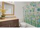 Stylish bathroom featuring a vanity with granite countertop and decorative shower curtain at 6358 Meadow Lark Ln, Las Vegas, NV 89103