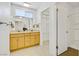 Bright bathroom with a double sink vanity, closet, and walk-in shower at 6358 Meadow Lark Ln, Las Vegas, NV 89103