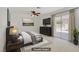 Bedroom featuring neutral tones, ceiling fan, and a sliding glass door to the patio at 6358 Meadow Lark Ln, Las Vegas, NV 89103