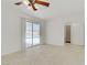 Clean bedroom with tile flooring, backyard views, and a connecting bathroom at 6358 Meadow Lark Ln, Las Vegas, NV 89103