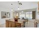 Bright kitchen with granite counters, island, modern lighting, and a view of the pool at 6358 Meadow Lark Ln, Las Vegas, NV 89103