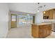 Well-lit kitchen with an island, granite countertops, and a view of the backyard pool at 6358 Meadow Lark Ln, Las Vegas, NV 89103