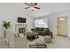 Comfortable living room features neutral colors, brick fireplace, and a ceiling fan at 6358 Meadow Lark Ln, Las Vegas, NV 89103