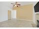 Open concept living room featuring tiled floors, modern paint and fireplace at 6358 Meadow Lark Ln, Las Vegas, NV 89103
