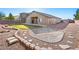 Expansive backyard featuring a patio and gravel area, perfect for outdoor entertaining and relaxation at 6360 Bullring Ln, Las Vegas, NV 89130