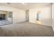 Spacious living room with plush carpeting and sliding glass doors leading to the outdoors at 6360 Bullring Ln, Las Vegas, NV 89130