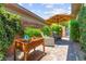 A backyard features a raised garden bed and comfortable seating under a patio umbrella at 6810 Silver Crescent St, Las Vegas, NV 89148